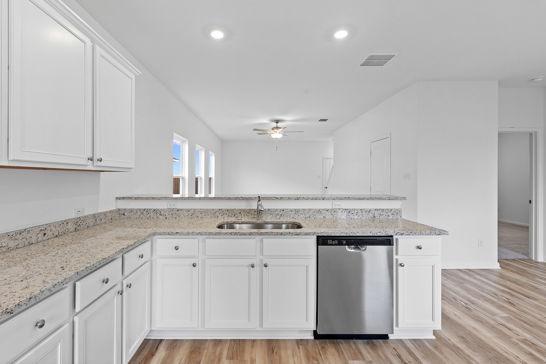 14408 Wahlbergs Way Elgin, TX 78621 - Photo 5 of 14 a kitchen with a sink stove and cabinets