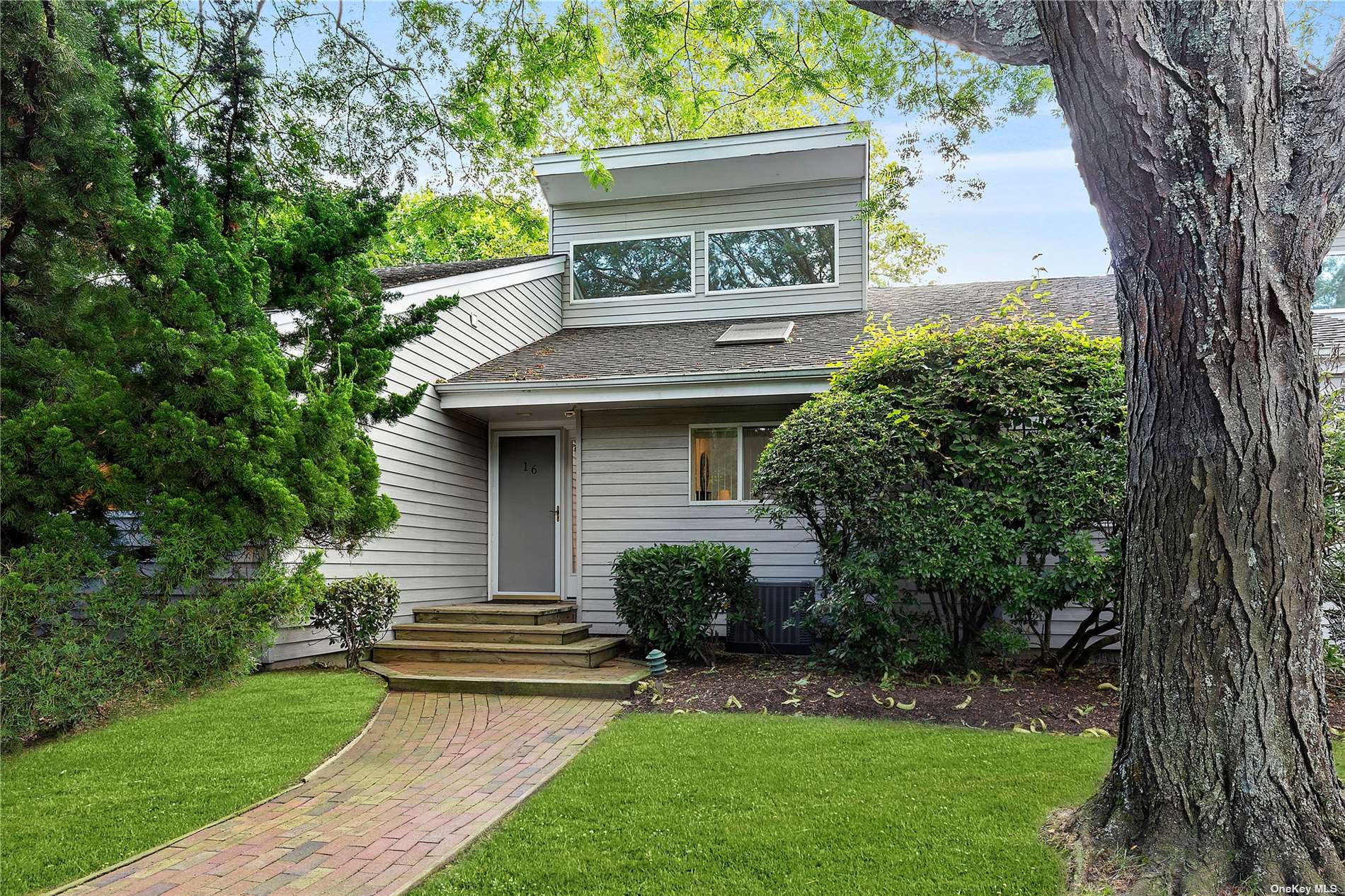 221 Mill Road, Unit 16 Westhampton Beach, NY 11978 - Photo 1 of 1 a view of a house with a yard