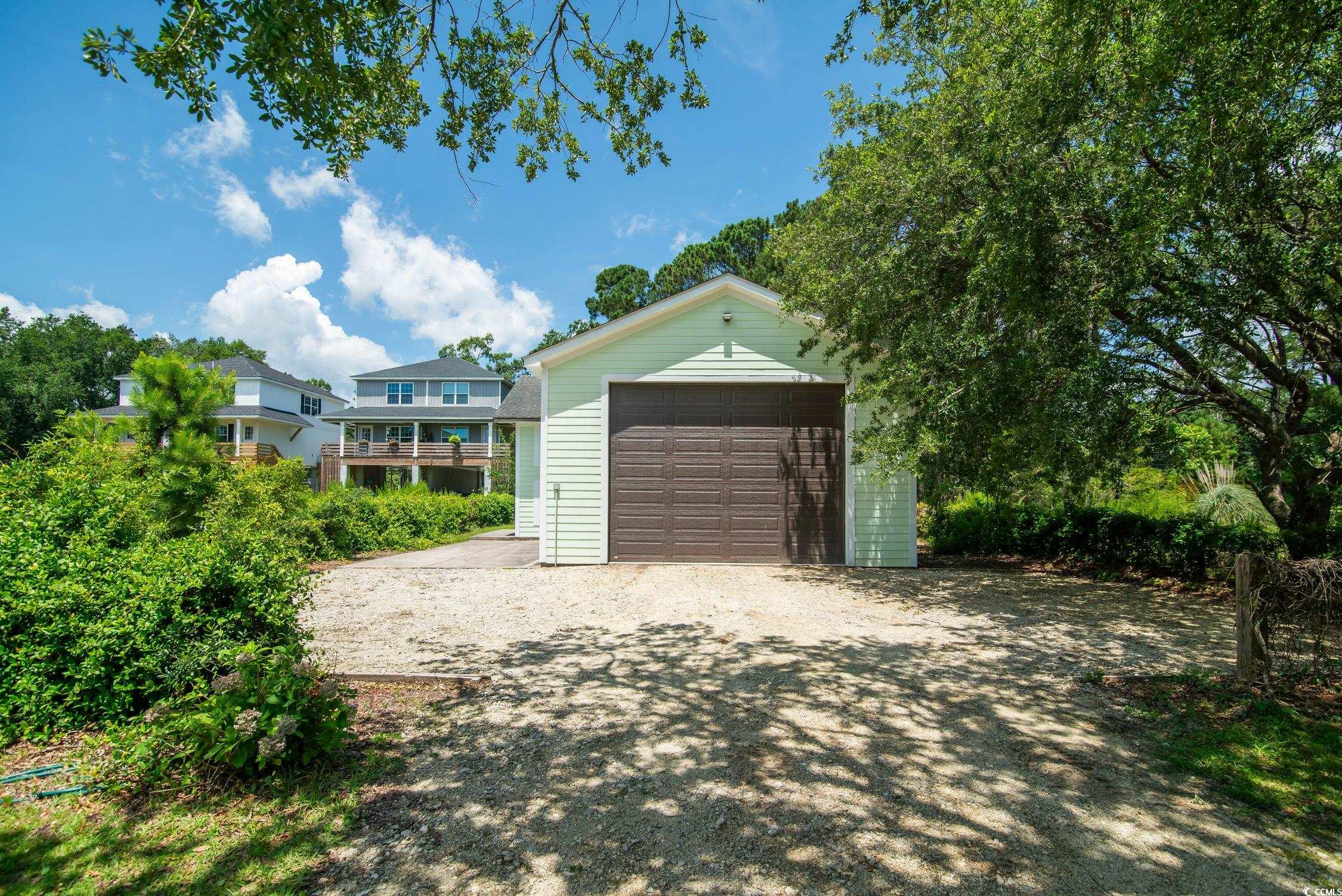 127 Brown Pelican Loop Pawleys Island, SC 29585 - Photo 1 of 31 Detached garage featuring driveway