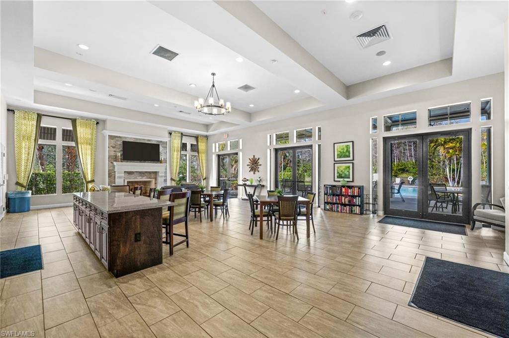 4754 Abaca Circle Naples, FL 34119 - Photo 44 of 46 a living room with furniture a flat screen tv and a large window