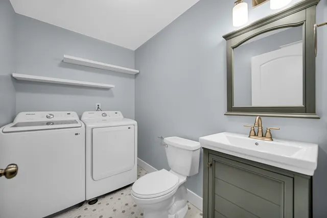 a bathroom with a toilet sink and mirror