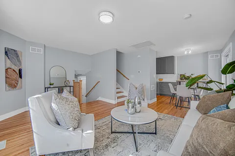 a living room with furniture and wooden floor