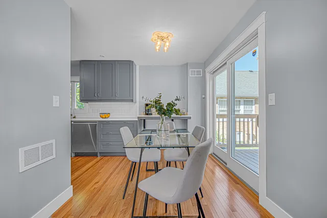 a view of a dining room with furniture a chandelier and wooden floor
