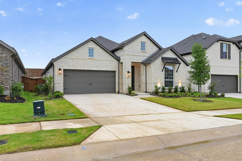 4123 Windy Point Court Oak Point, TX 75068 - Photo 8 of 29 Contemporary brick exterior with a dark shingle roof and a two-car garage