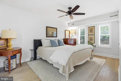 a spacious bedroom with a bed and a chandelier
