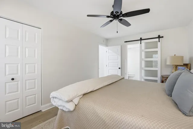 a bedroom with a bed and a ceiling fan
