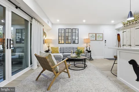 a living room with furniture a window and gym equipment