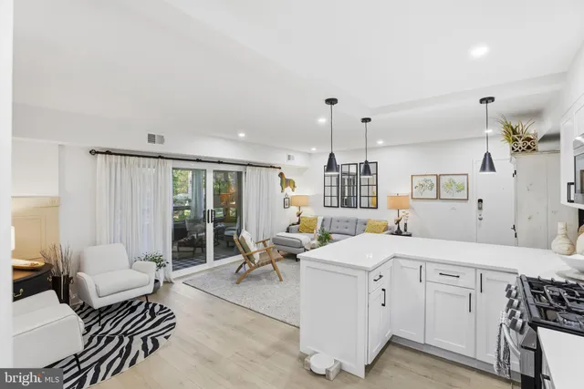 a room with a bed furniture and a large window