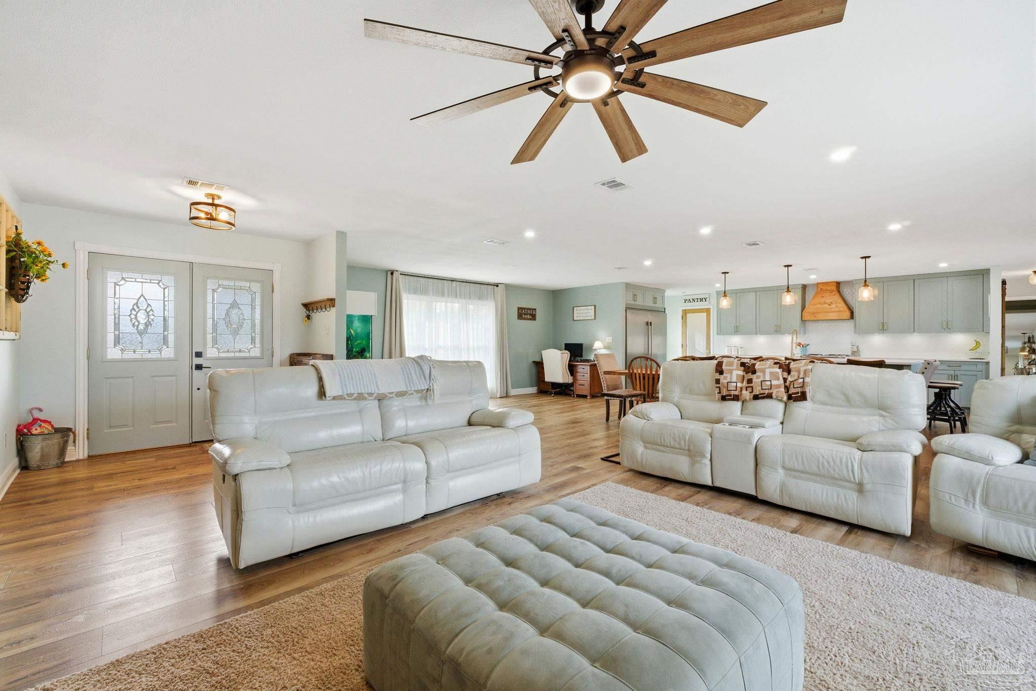 690 Cooley Road Cantonment, FL 32533 - Photo 12 of 64 a living room with furniture and a chandelier