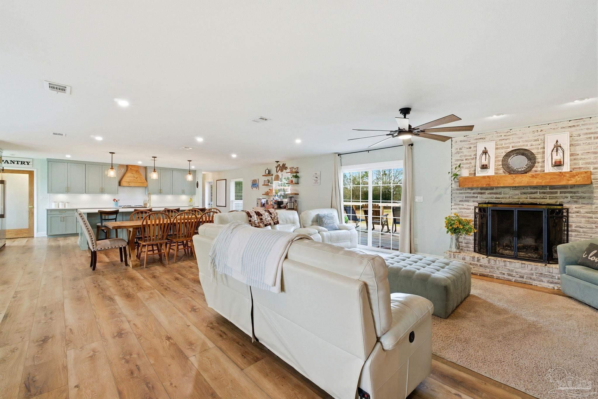 690 Cooley Road Cantonment, FL 32533 - Photo 13 of 64 a living room with furniture and a fireplace