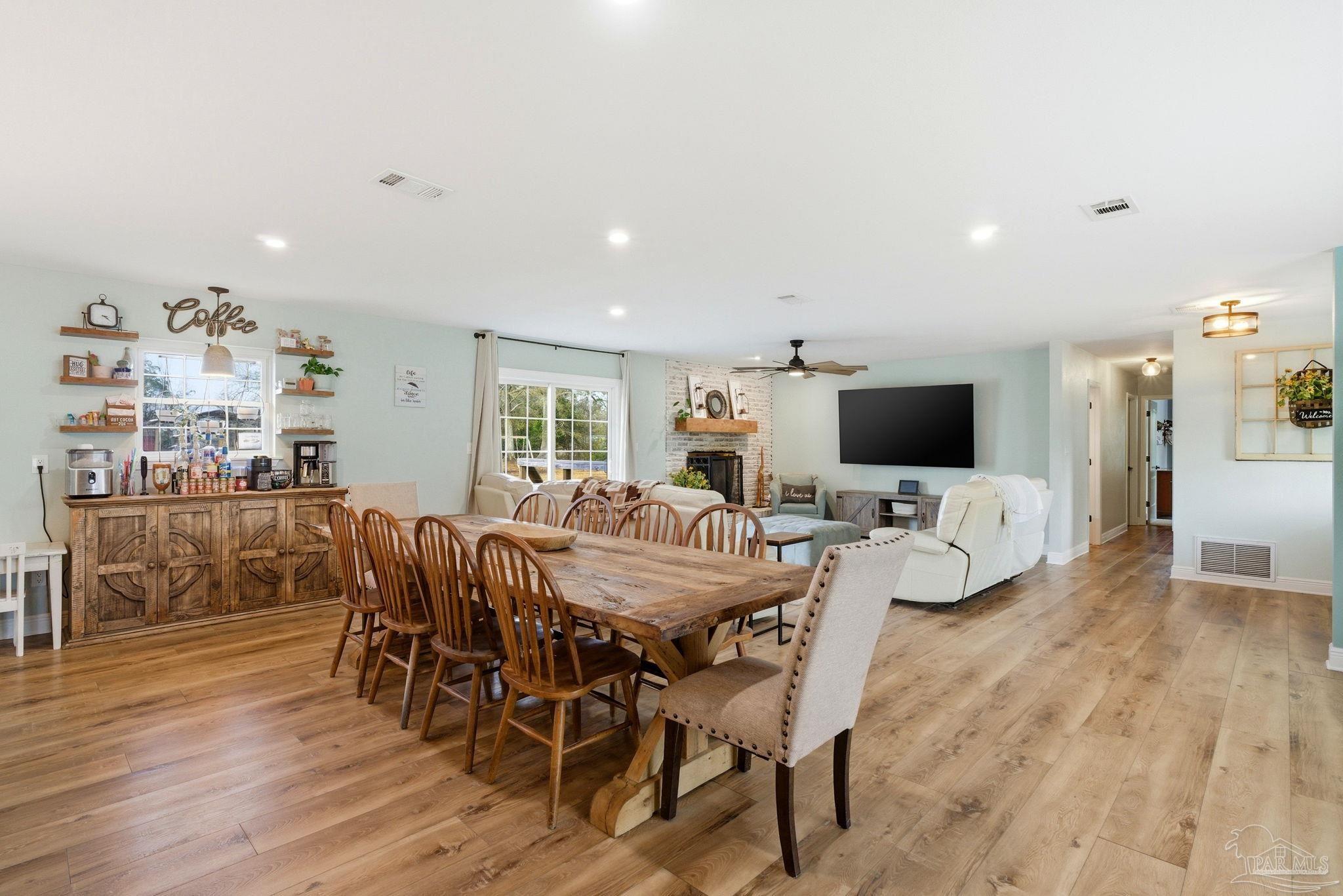 690 Cooley Road Cantonment, FL 32533 - Photo 18 of 64 a view of a dining room with furniture and wooden floor