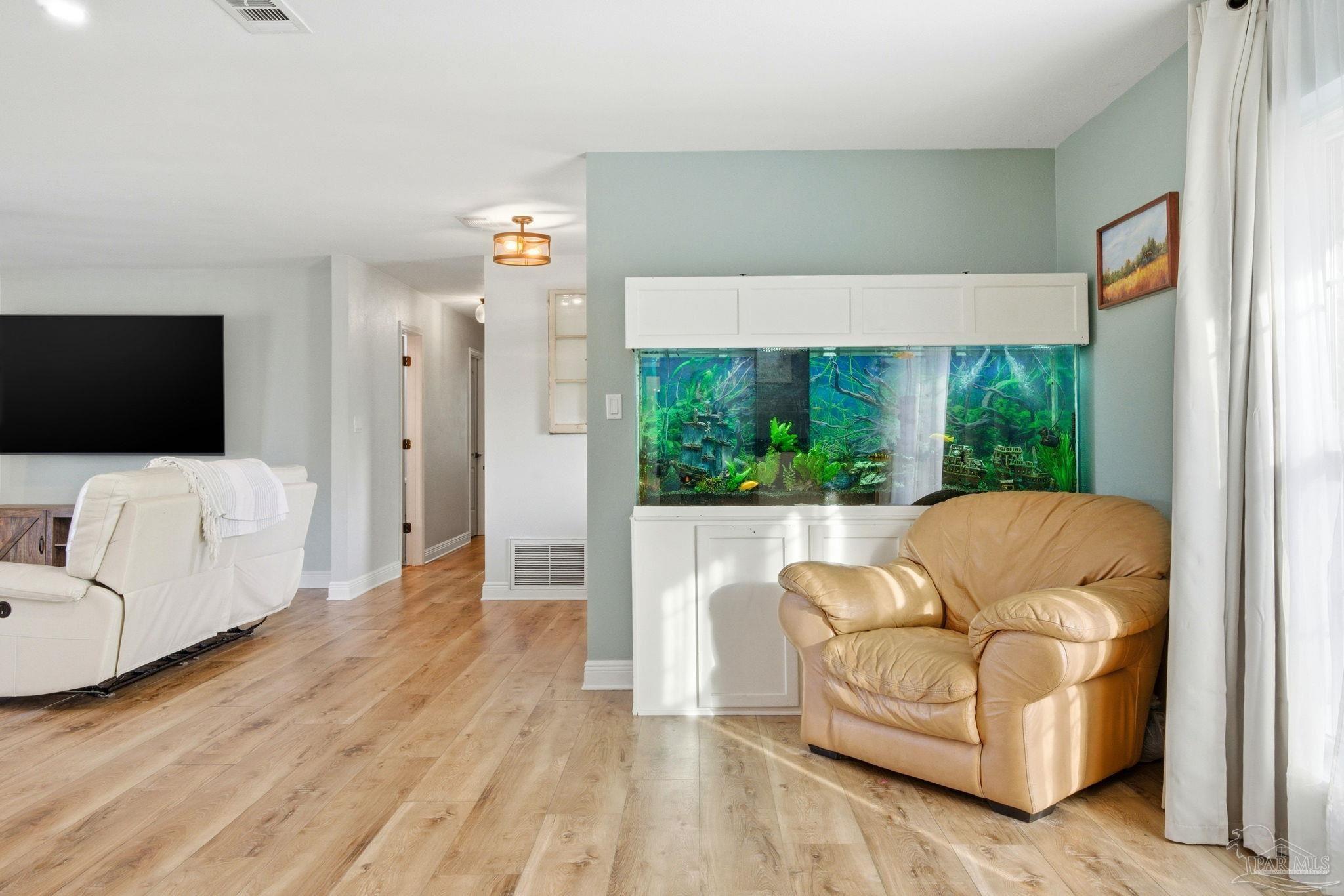 690 Cooley Road Cantonment, FL 32533 - Photo 21 of 64 a living room with furniture and a flat screen tv