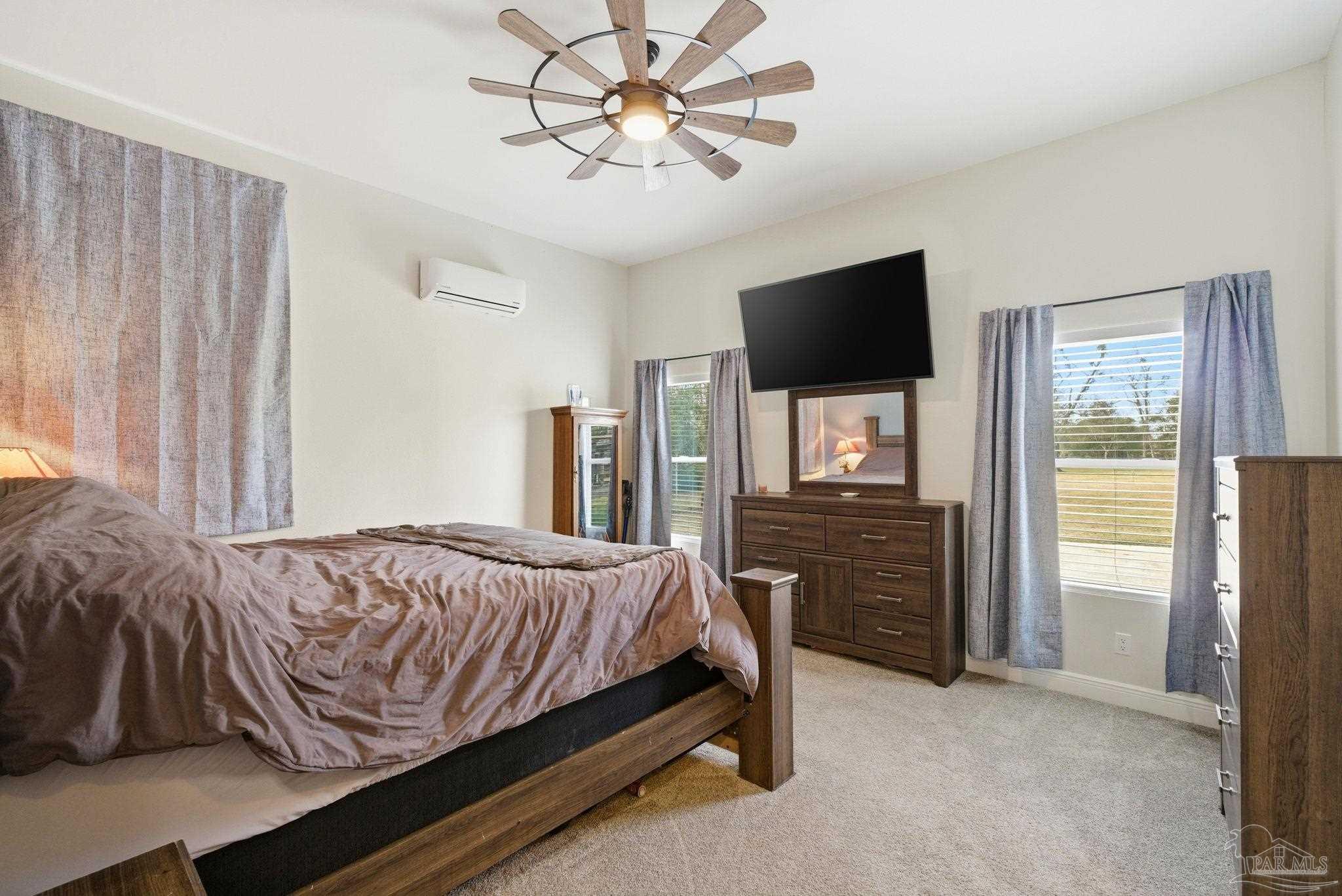 690 Cooley Road Cantonment, FL 32533 - Photo 23 of 64 a bedroom with a bed and a flat screen tv