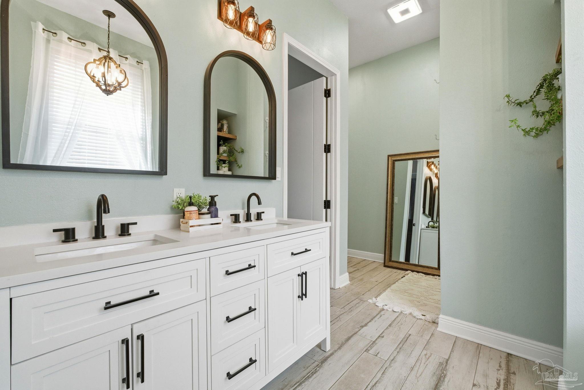 690 Cooley Road Cantonment, FL 32533 - Photo 24 of 64 a bathroom with a double vanity sink and a mirror