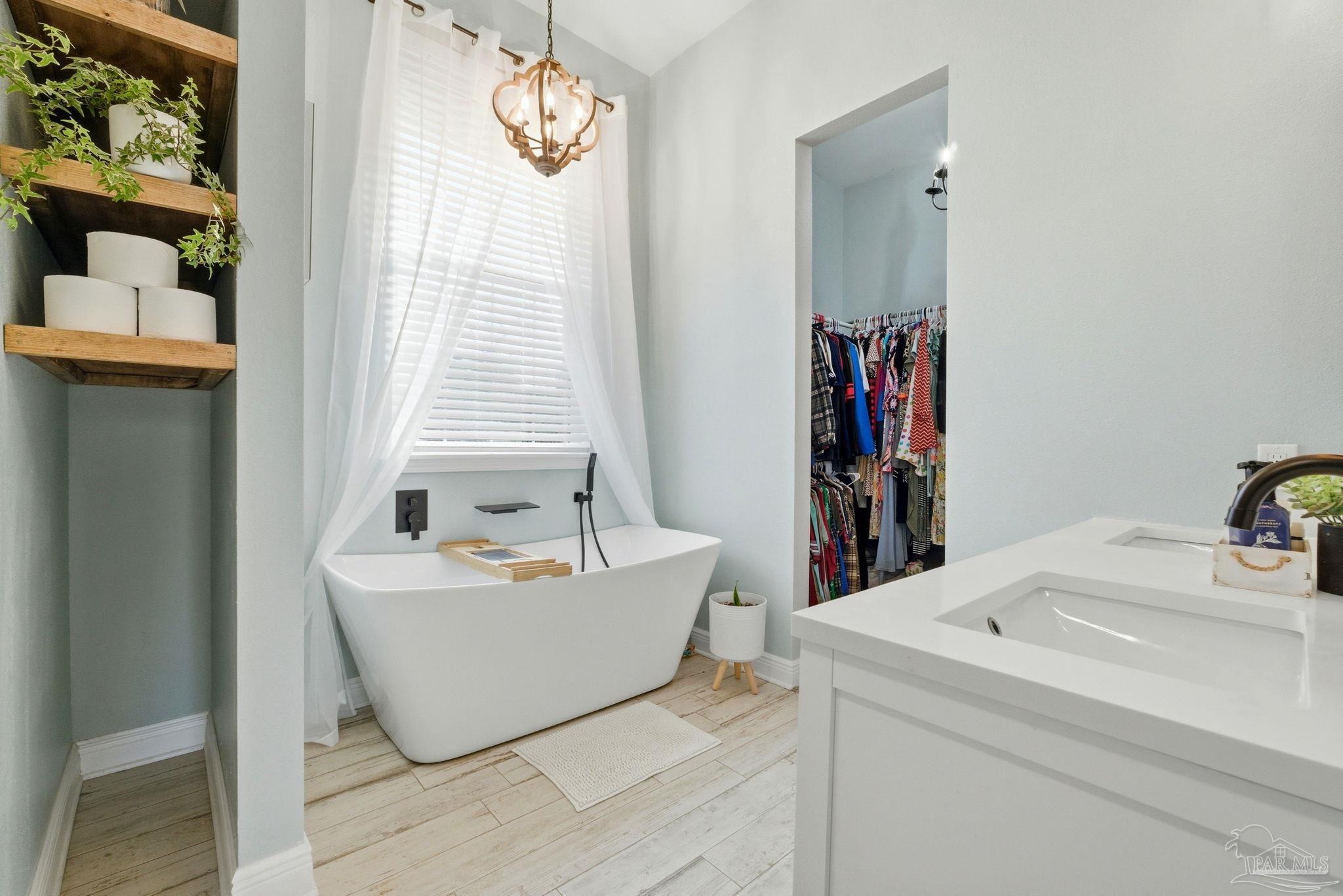 690 Cooley Road Cantonment, FL 32533 - Photo 26 of 64 a bathroom with a tub sink and mirror