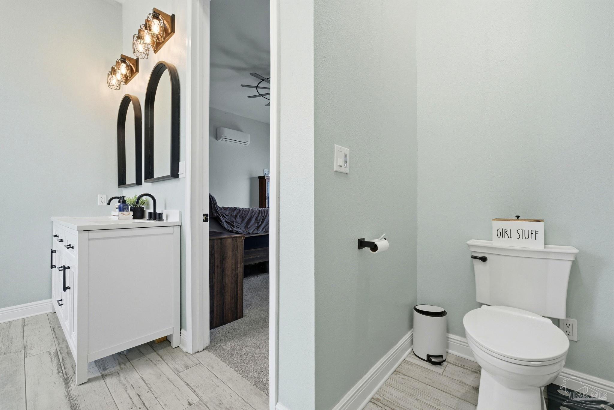 690 Cooley Road Cantonment, FL 32533 - Photo 27 of 64 a bathroom with a toilet sink and mirror