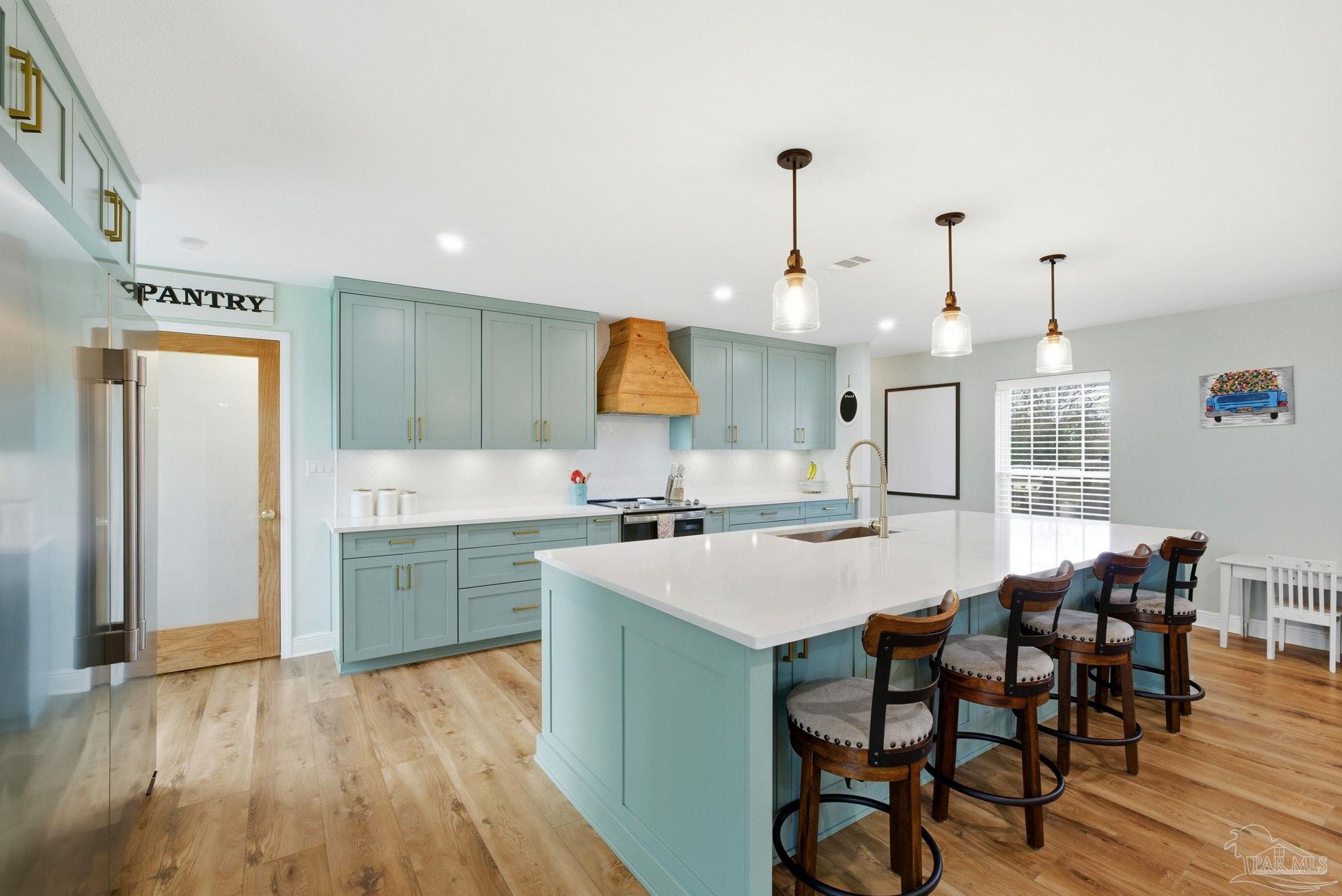 690 Cooley Road Cantonment, FL 32533 - Photo 3 of 64 a kitchen with a table chairs sink and cabinets