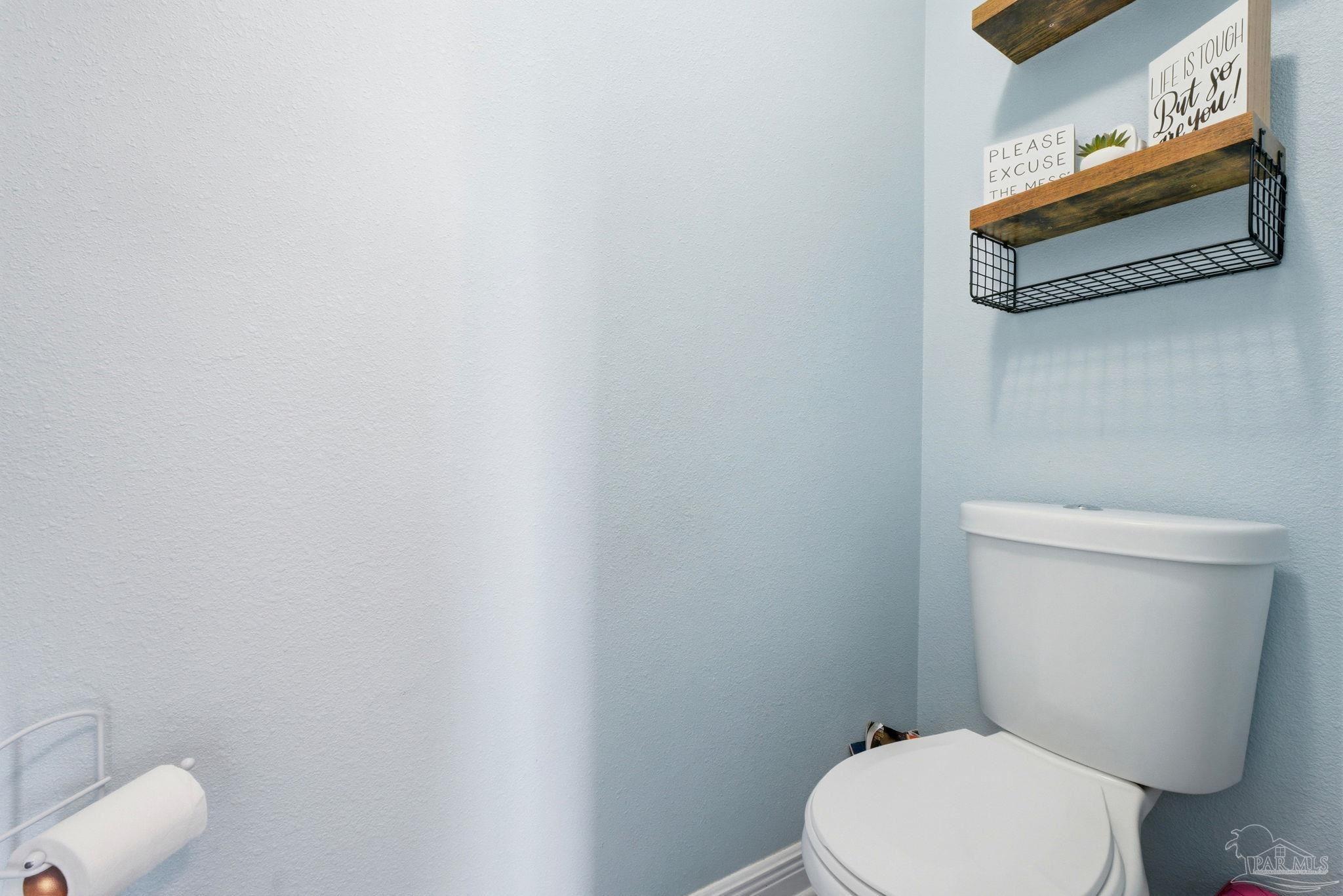 690 Cooley Road Cantonment, FL 32533 - Photo 40 of 64 a white toilet sitting next to a white cabinet