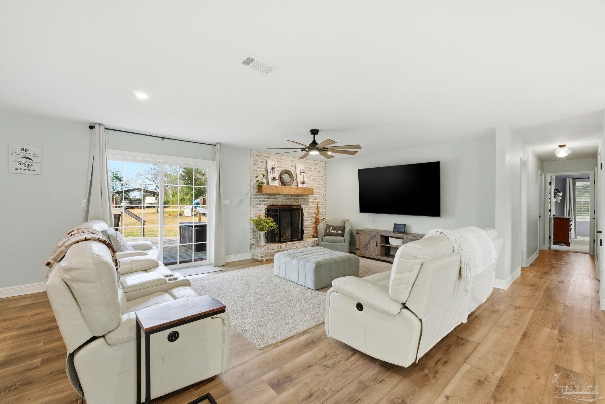 690 Cooley Road Cantonment, FL 32533 - Photo 4 of 64 a living room with furniture and a flat screen tv