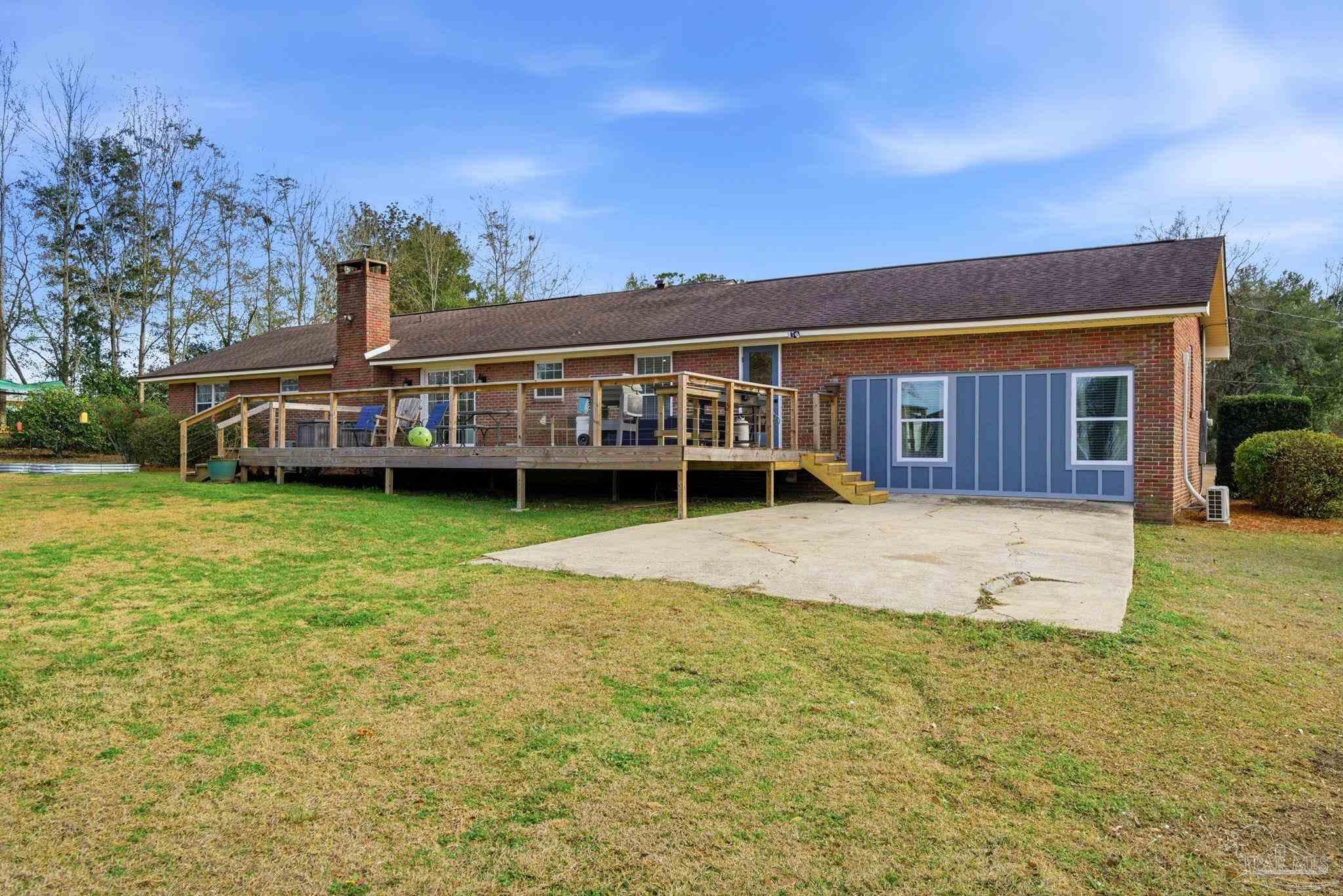 690 Cooley Road Cantonment, FL 32533 - Photo 45 of 64 a view of a house with a garden and deck