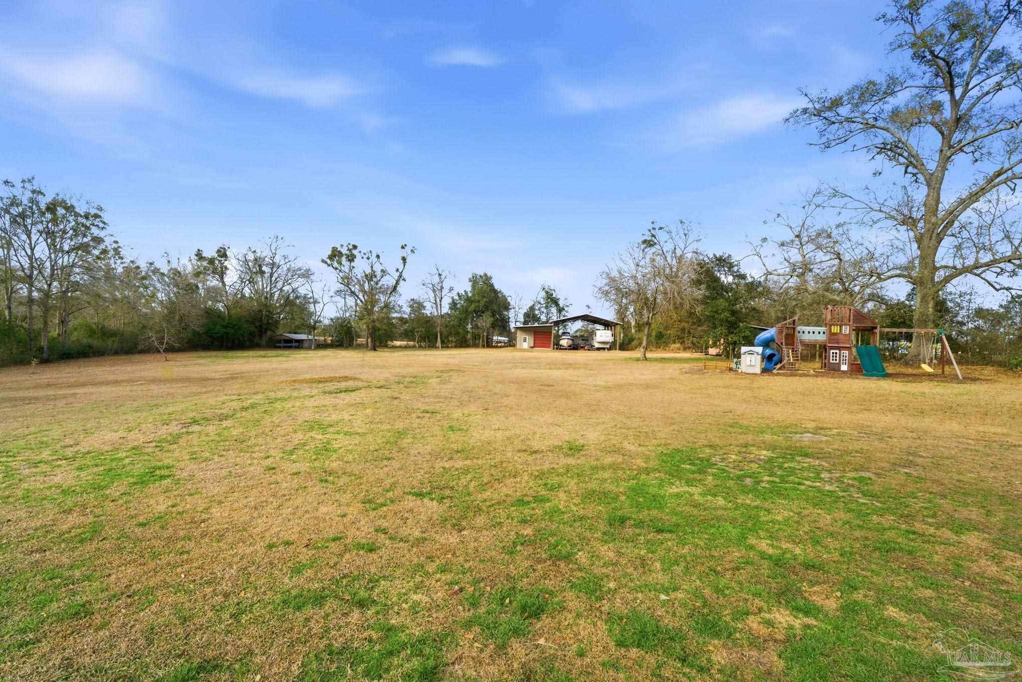 690 Cooley Road Cantonment, FL 32533 - Photo 48 of 64 a view of outdoor space with garden and trees