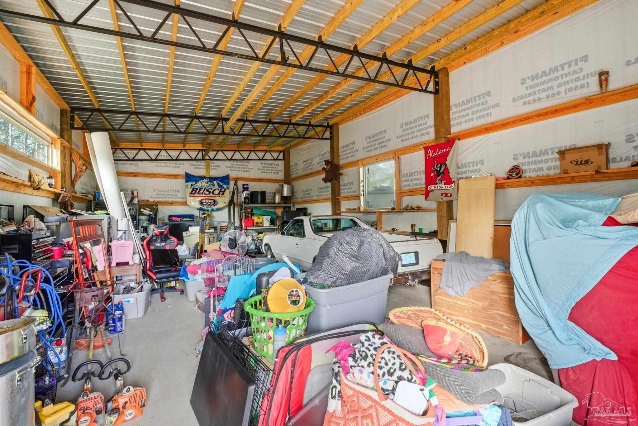 690 Cooley Road Cantonment, FL 32533 - Photo 52 of 64 a store room with lots of different colored cloths