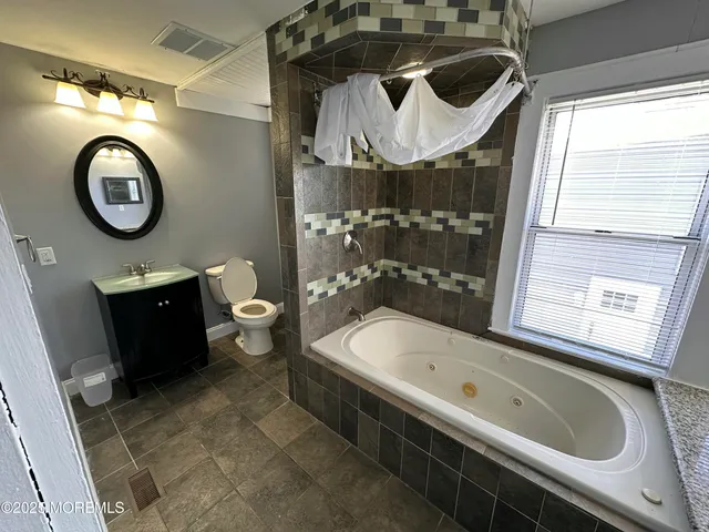 a bathroom with a sink a toilet and a bathtub