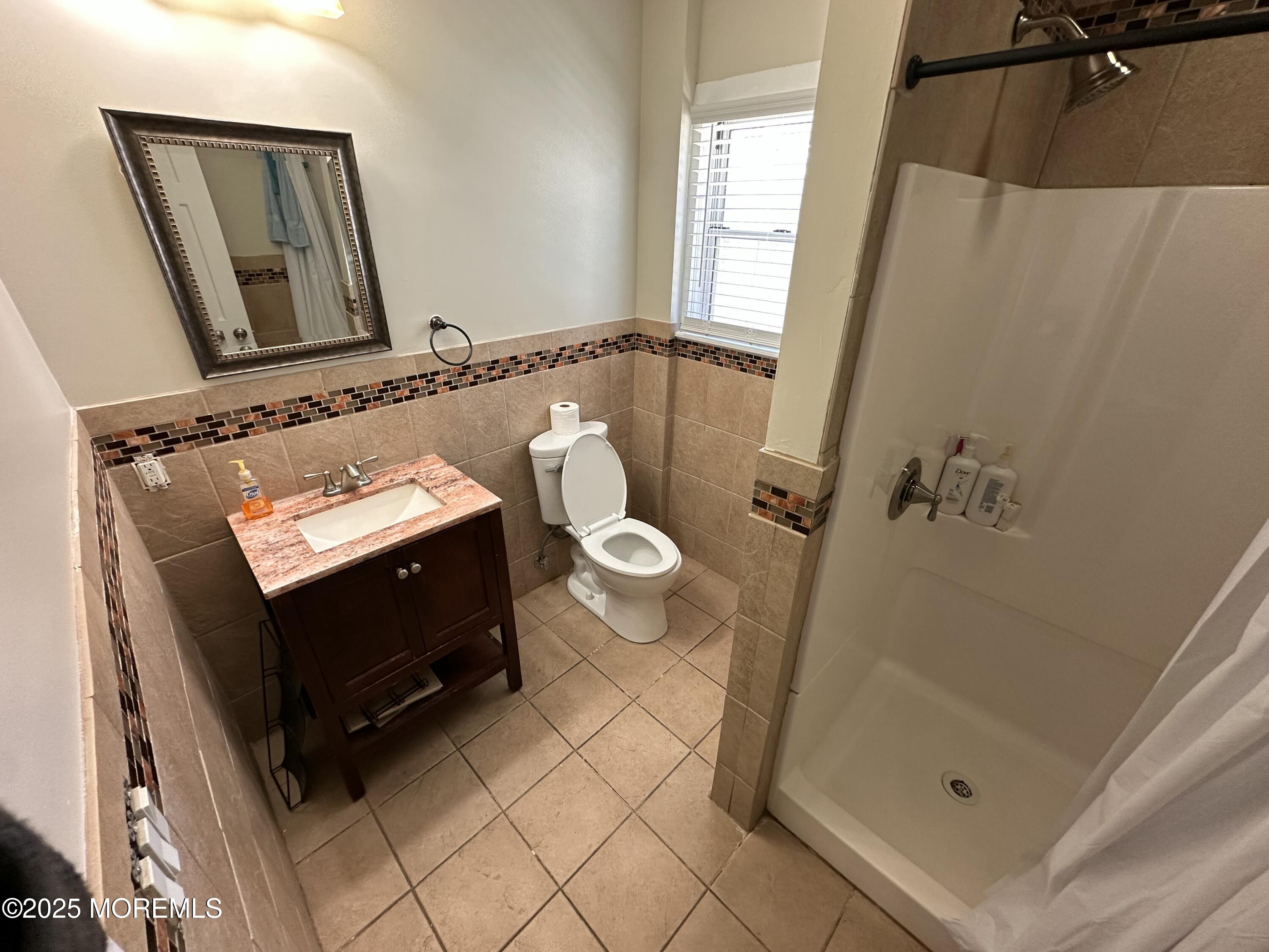 203 16th Avenue Belmar, NJ 07719 - Photo 13 of 13 a bathroom with a sink a mirror and a toilet