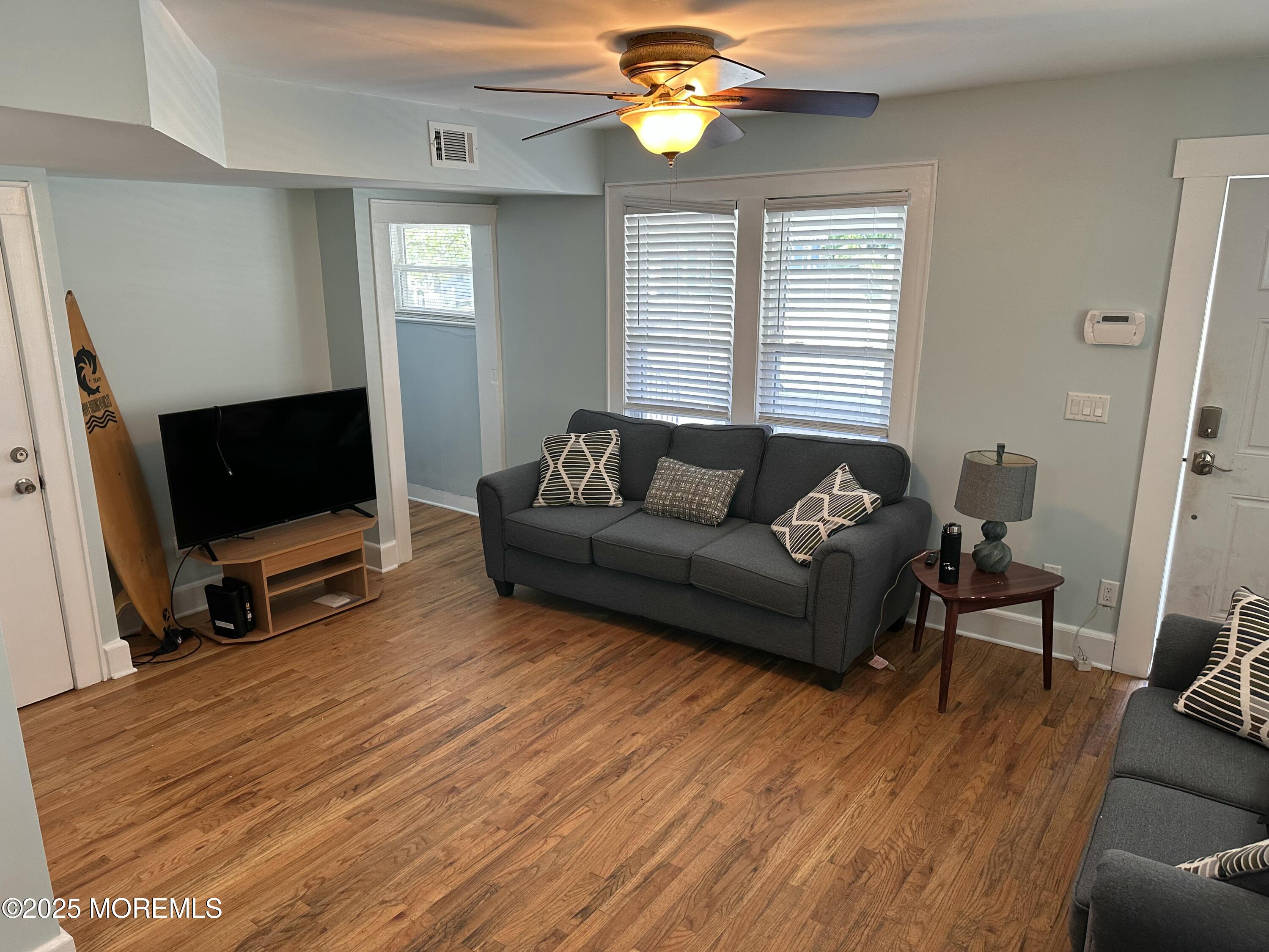 203 16th Avenue Belmar, NJ 07719 - Photo 2 of 13 a living room with furniture and a flat screen tv