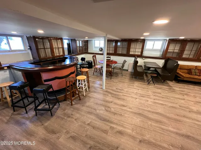a living room with lots of furniture and a wooden floor