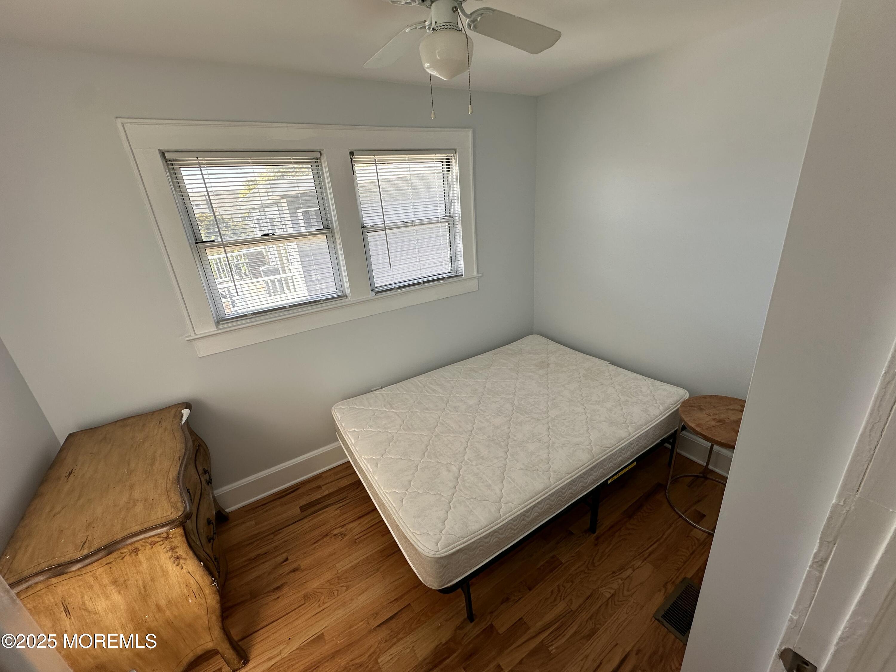 203 16th Avenue Belmar, NJ 07719 - Photo 7 of 13 a living room with a bed furniture and a window
