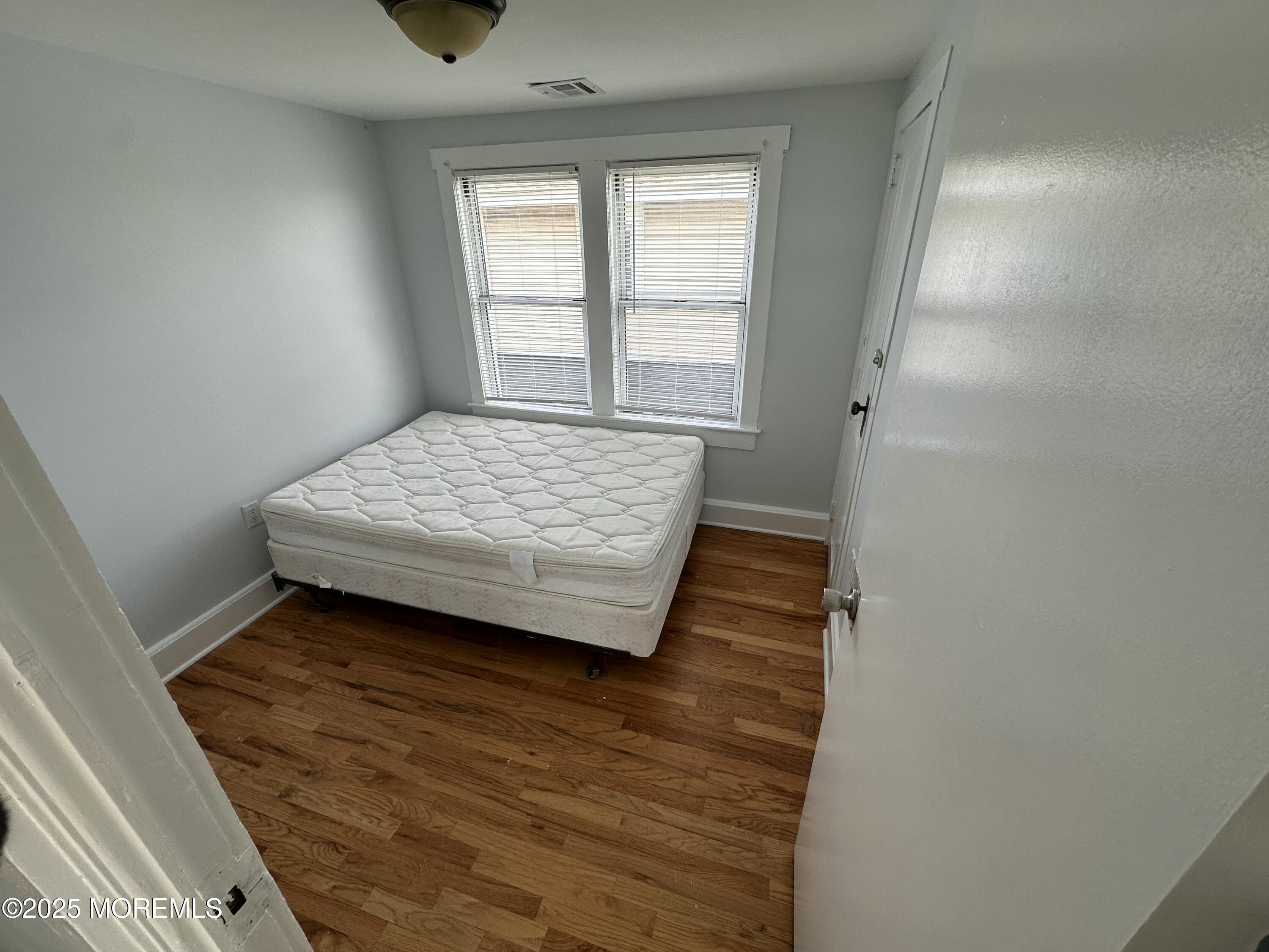203 16th Avenue Belmar, NJ 07719 - Photo 9 of 13 a bedroom with a bed and window