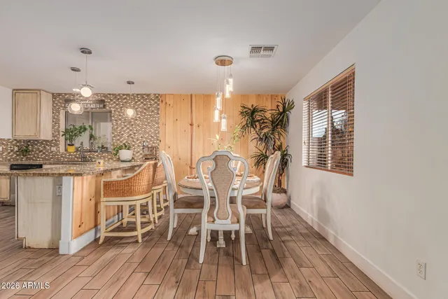 a kitchen with stainless steel appliances granite countertop a sink refrigerator and cabinets