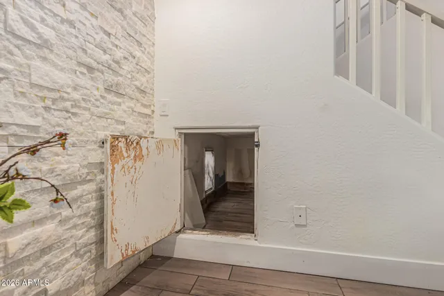 a view of empty room with wooden floor and ceiling fan