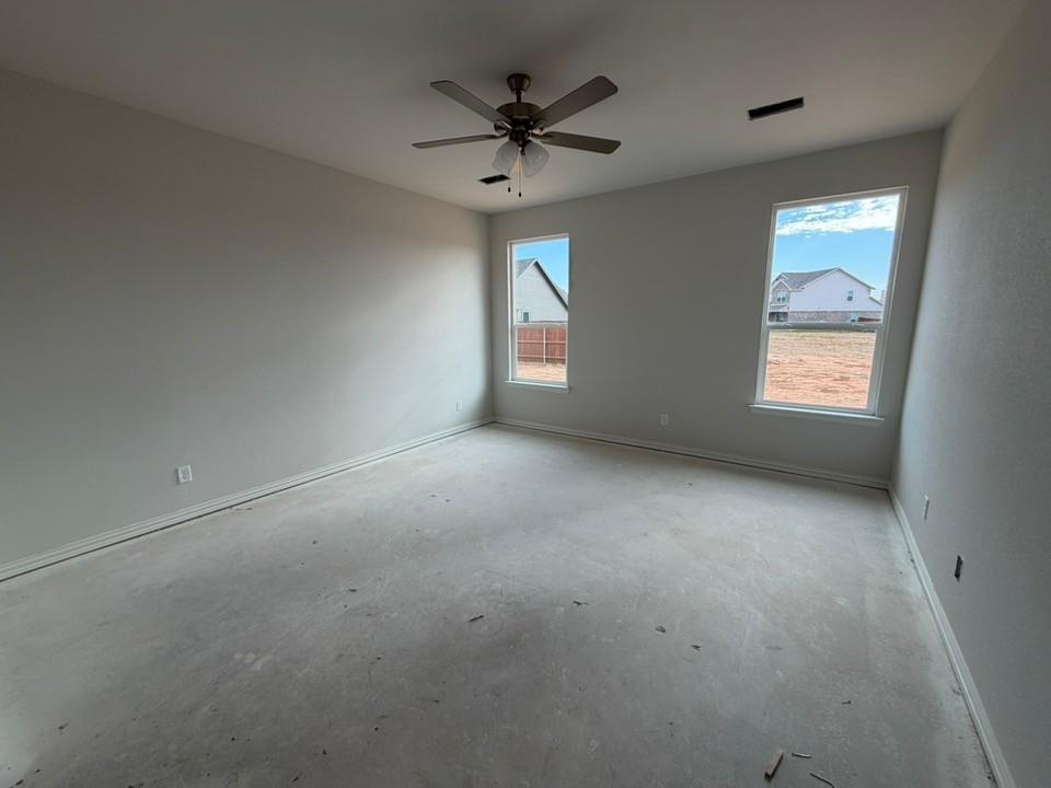 1224 Sabine River Lane Springtown, TX 76082 - Photo 7 of 17 an empty room with windows and ceiling fan