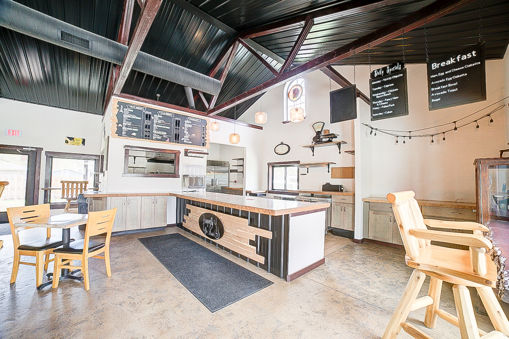 201 Main Street Crescent City, IL 60928 - Photo 14 of 65 a large white kitchen with a stove a sink a dining table and chairs with wooden floor
