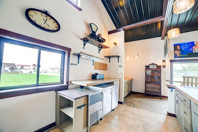 a kitchen with kitchen island a counter top space a sink and stainless steel appliances