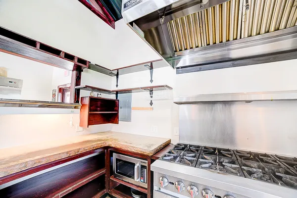 a kitchen with stove and cabinets