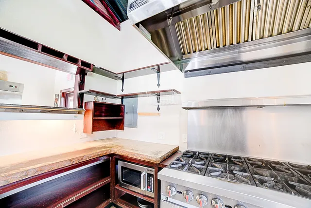 a kitchen with stove and cabinets