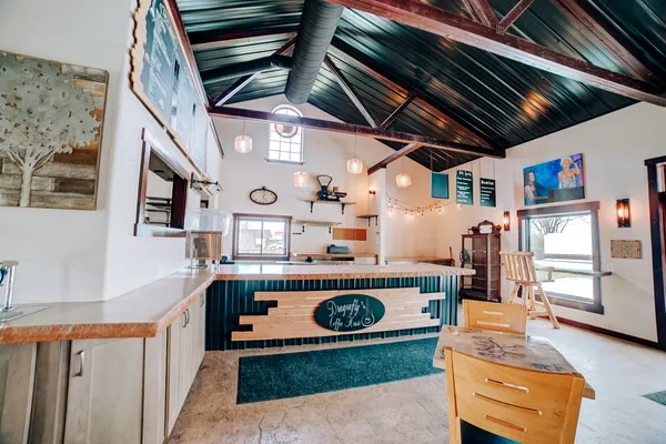 a bedroom with furniture and a large window