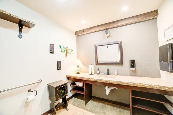 a bathroom with a toilet a sink and a mirror