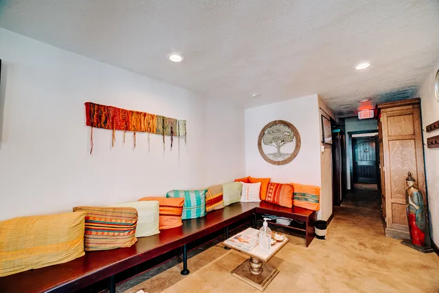 an empty room with windows and ceiling fan