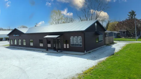 a view of a house with a yard and garage