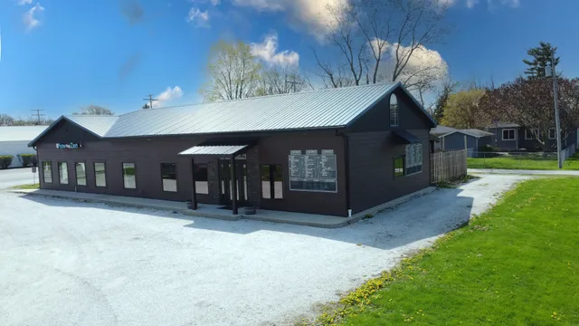 a view of a house with a yard and garage