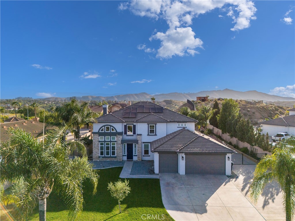 16715 Alderidge Court Riverside, CA 92503 - Photo 1 of 1 a front view of a house with a garden and trees