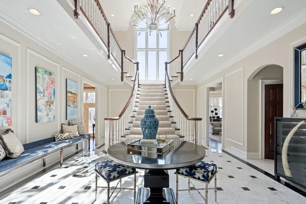 a view of staircase with wooden floor and a large window