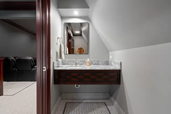 a bathroom with a granite countertop sink and a mirror