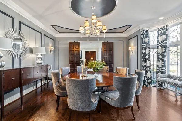 an open kitchen with wooden floor and stainless steel appliances