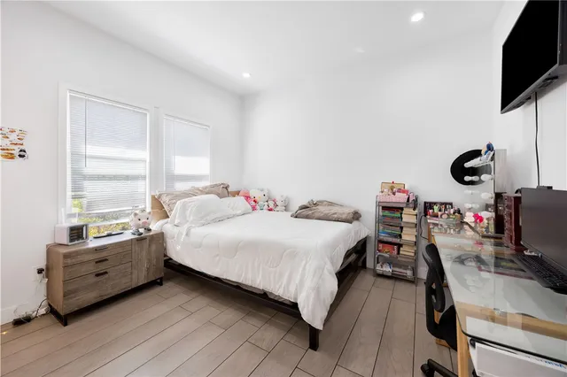 a bedroom with a bed and a flat screen tv