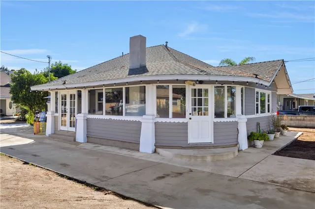 a front view of a house with a garden